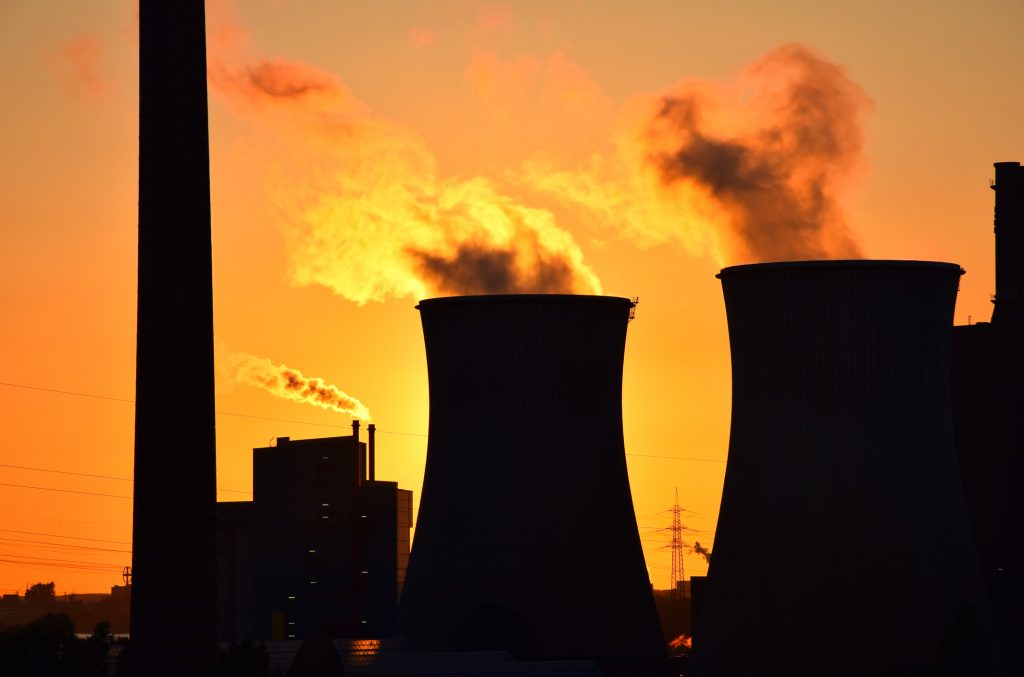 Silhouette of the plant smokestack polluting the air